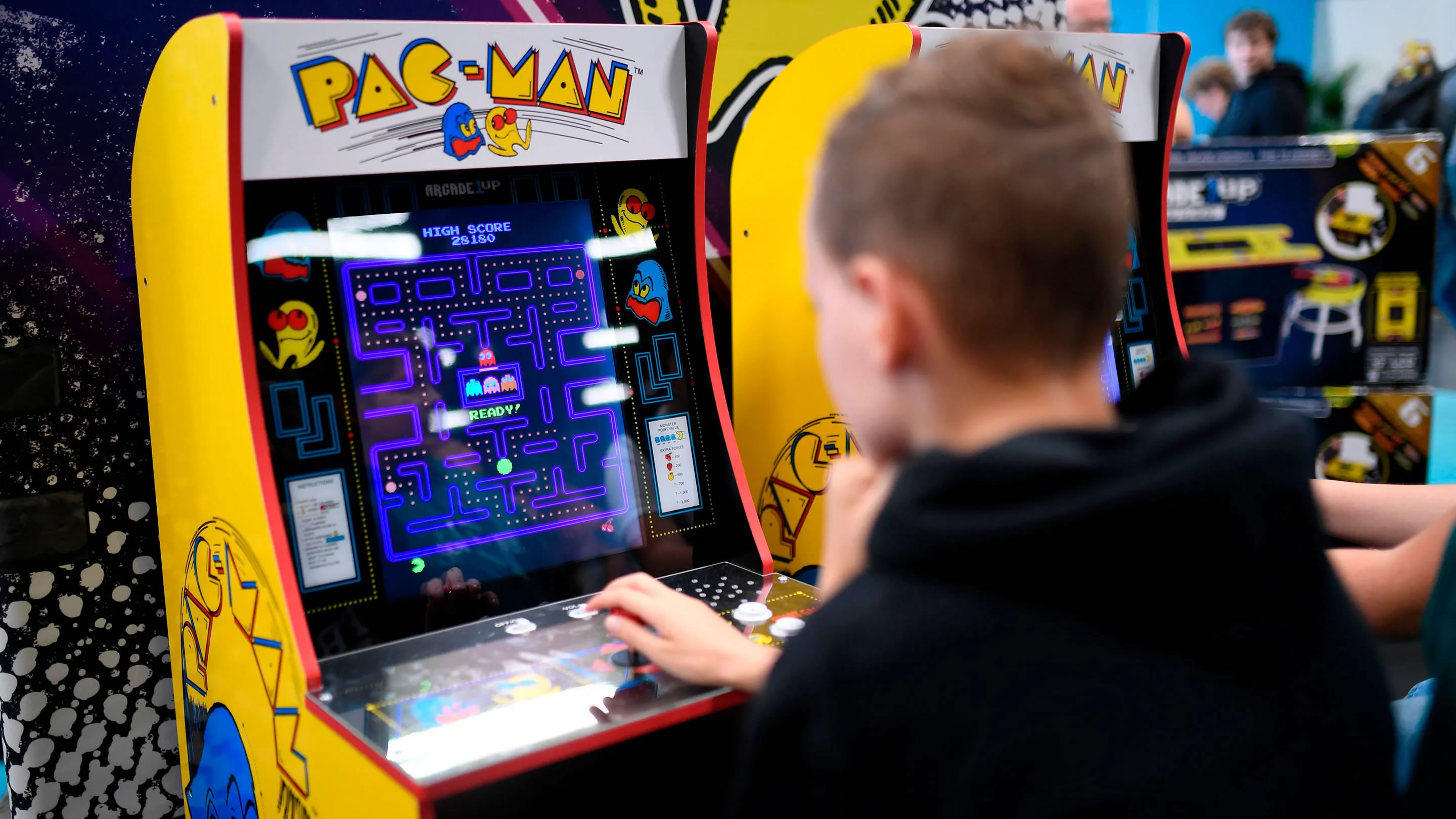 Person playing PacMan arcade